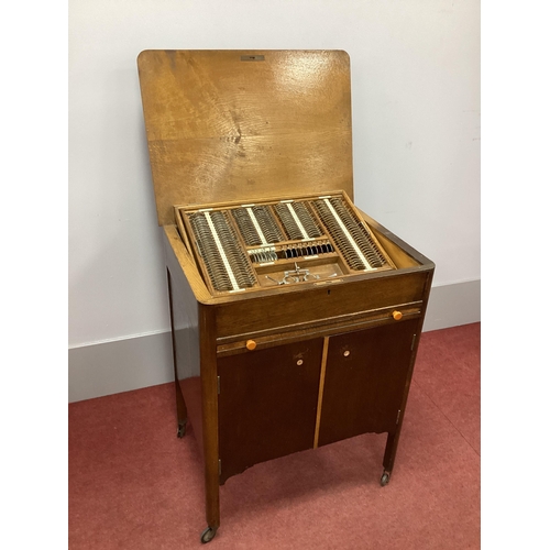 1272 - A 1930's Oak Cased Wheeled Cabinet of Optician's Lenses, with lift-up top, sliding shelf and two doo... 