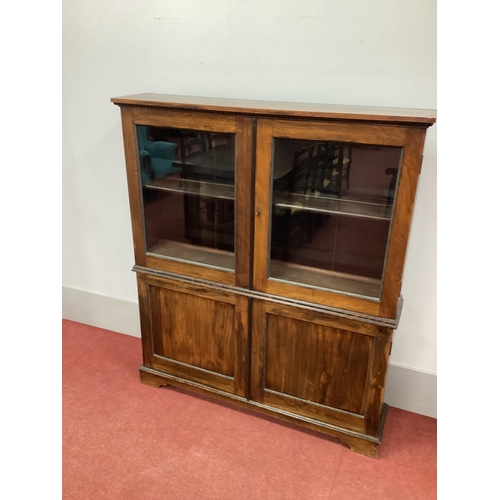 1480 - A XIX Century Rosewood Cabinet, with twin upper glazed doors with two internal shelves over panelled... 