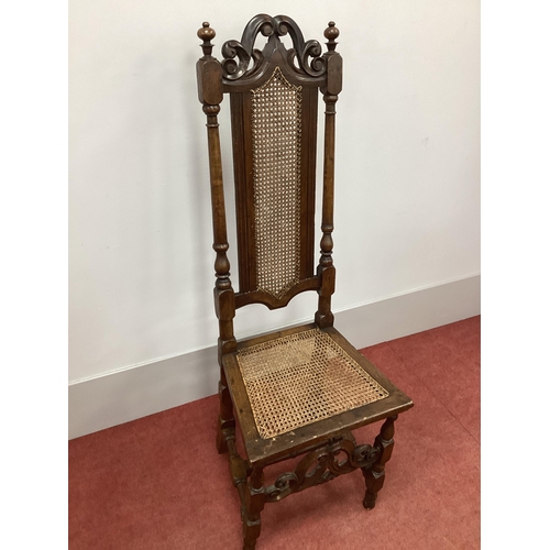 1484 - A XVII Century High Back Chair, with a scroll and pierced top rail, caned back and seat, on turned a... 