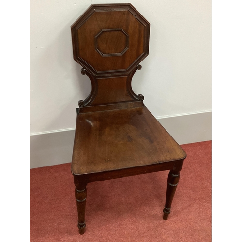 1487 - An Early XIX Century Regency Mahogany Hall Chair, with octagonal panelled back, 'C' scrolls, and sol... 