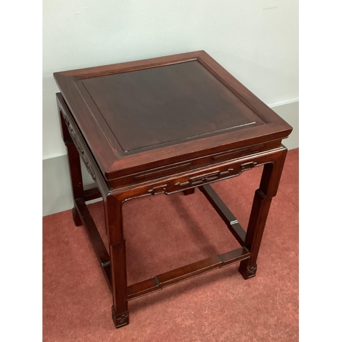 1503 - A Chinese Hardwood Table, with panelled top, shaped frieze and shaped supports united by stretchers,... 