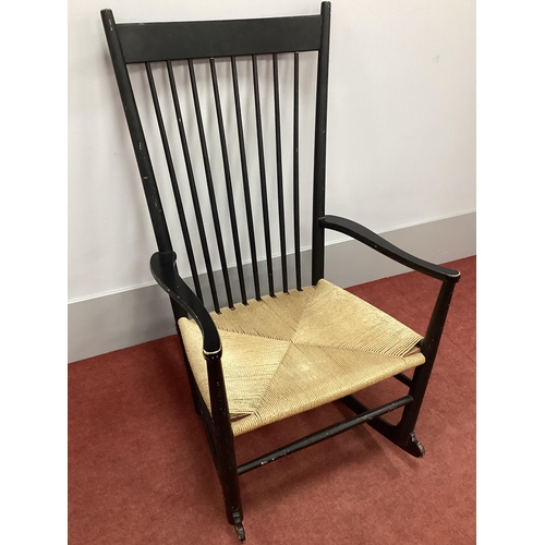 1506 - Hans J. Wenger; A Mid XX Century Ebonised Rocking Chair, model J16, with original cord seat.