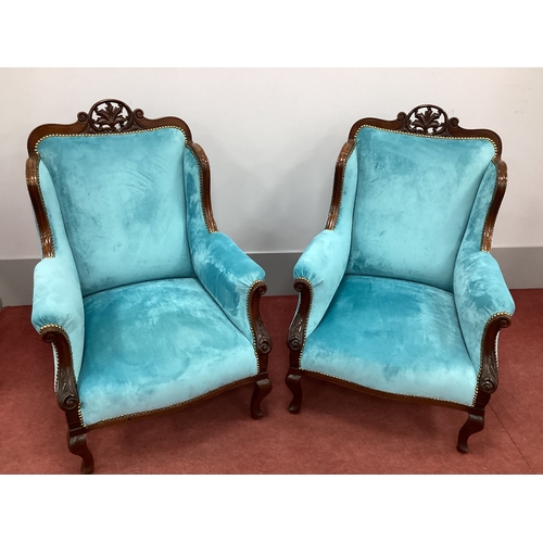 1507 - A Pair of Early XX Century Mahogany Armchairs, with a shaped top rail and shaped scroll arms, uphols... 