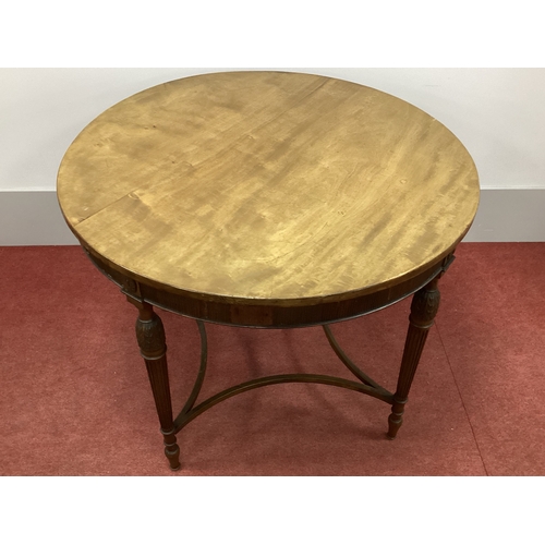 1516 - An Early XX Century Mahogany Centre Table, with circular top on reeded supports united by shaped str... 