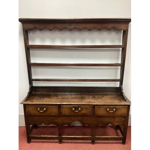 1526 - A Mid XVIII Century Joined Oak Dresser, the rack with a stepped moulded cornice, shaped pelmet and t... 