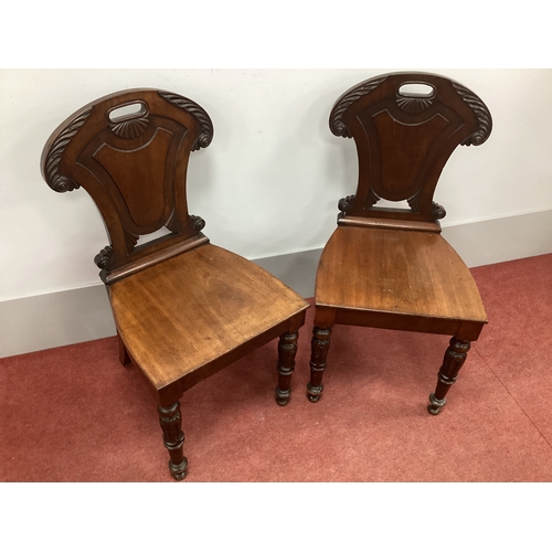 1528 - A Pair of William IV Mahogany Hall Chairs, with scroll and foliate decoration, panel back and solid ... 