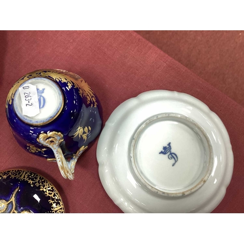 1075 - A German Early XX Century Porcelain Cabaret Set, the dark blue grounds decorated in panels with harb... 