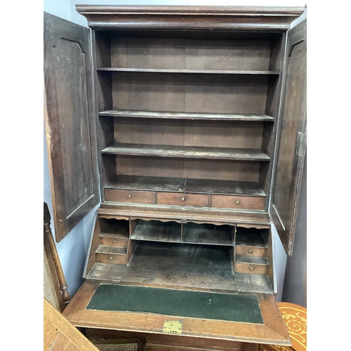 1485 - A Georgian Oak Bureau Bookcase, with twin panelled doors over fall front, fitted interior over two s... 