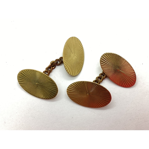 153 - A Pair of 9ct Gold Gent's Cufflinks, the oval panels with starburst style decoration, on chain link ... 