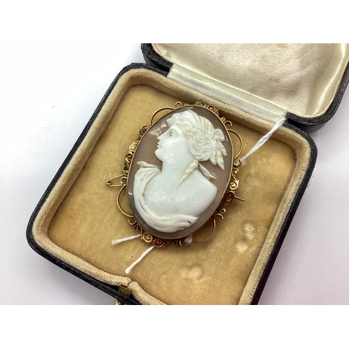 157 - A Shell Carved Cameo Brooch, depicting female profile, within openwork scroll mount, stamped 