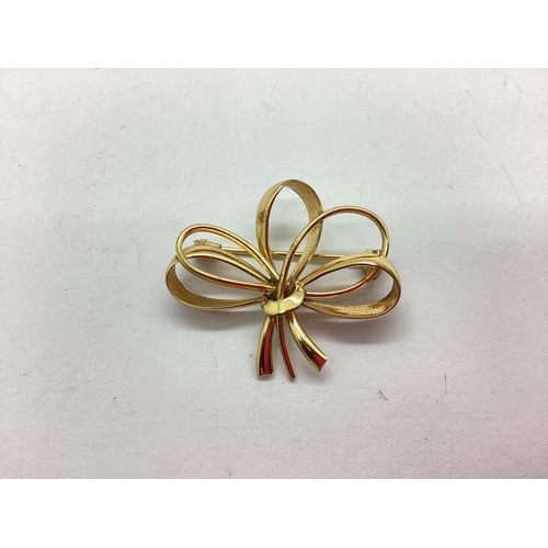 61 - A Modern Abstract Style Brooch, of sinuous bow boquet design, approximately 3.5cm.