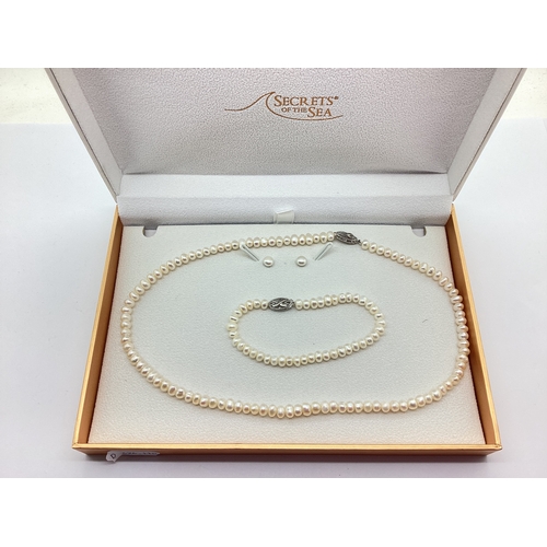 96 - A Modern Hallmarked Silver Clasped Freshwater Pearl Bead Necklace, the fancy clasp with illusion set... 