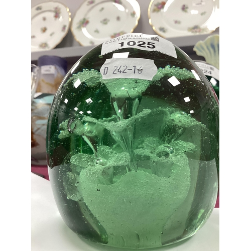 1211 - A Late XIX Century Green Glass Dump Paperweight, with flowerhead inclusions, 12cm high. Some surface... 