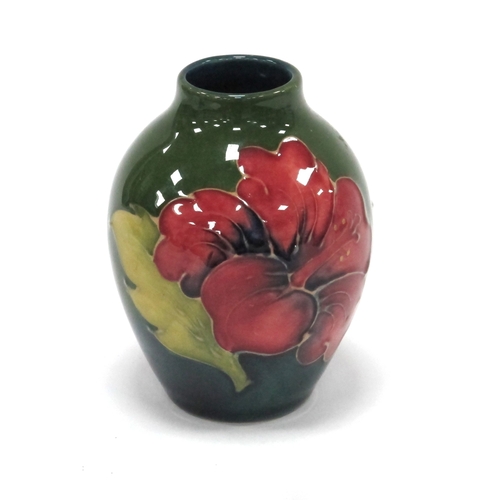 1212 - Moorcroft Pottery Hibiscus Design Vase, of ovoid form, on green ground 9cm high.