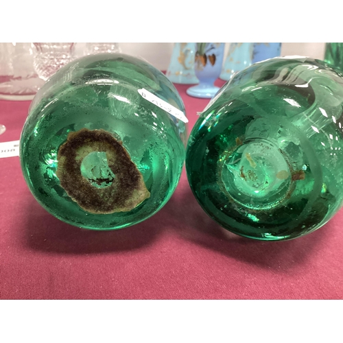 1218 - A Pair of Late XIX Century Green Glass Dumps, with floral inclusions, 13cm high. (2) Bases rough and... 