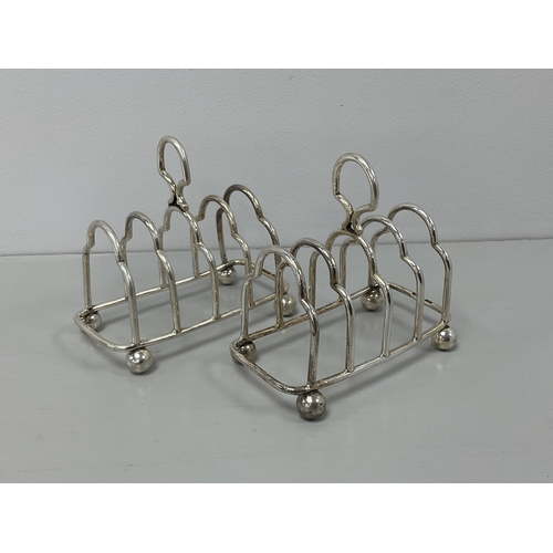 10 - A Pair of Hallmarked Silver Five Bar Toast Racks, GH, Sheffield 1918, each of shaped design and rais... 