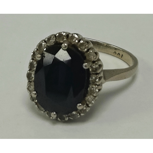 42 - A Diamond and Stone Set Cluster Ring, the oval centre stone six claw set within diamond surround, be... 