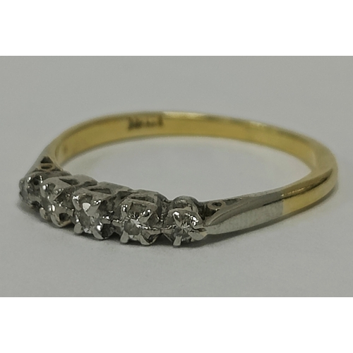 44 - A Five Stone Diamond Dress Ring, the brilliant cut diamonds graduated claw set throughout, between t... 