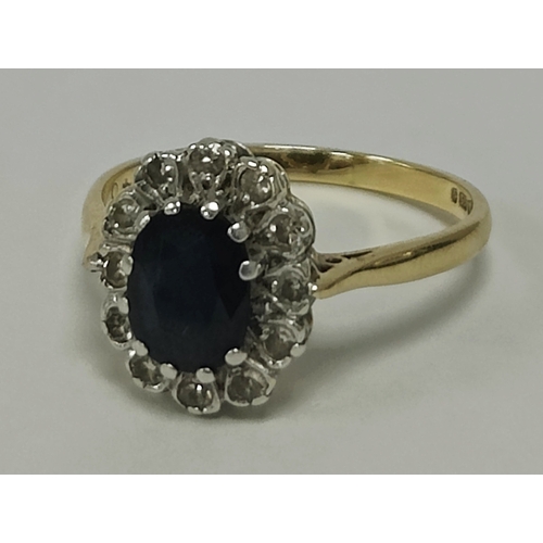 45 - A 9ct Gold Stone Set Cluster Ring, the oval centre stone claw set within diamond illusion set surrou... 