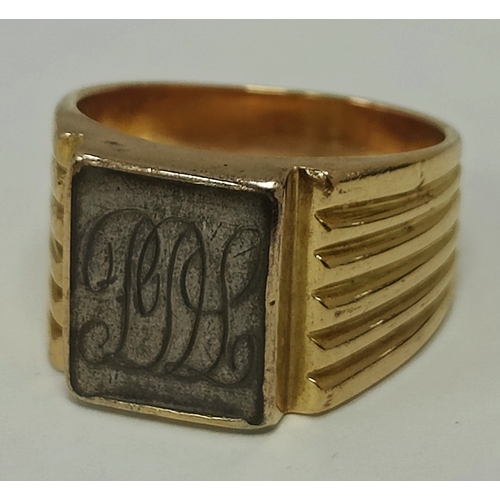 50 - An Egyptian Gent's Signet Style Ring, with inset initialled square panel, between wide tapering reed... 