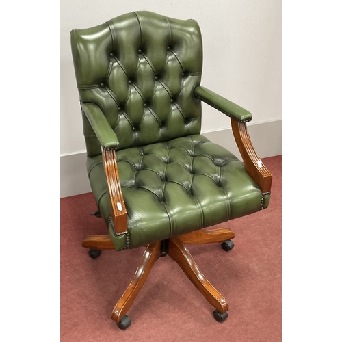 1580 - Green Leather Office Swivel Armchair, with button back and seat, stud decoration, open arms on shape... 