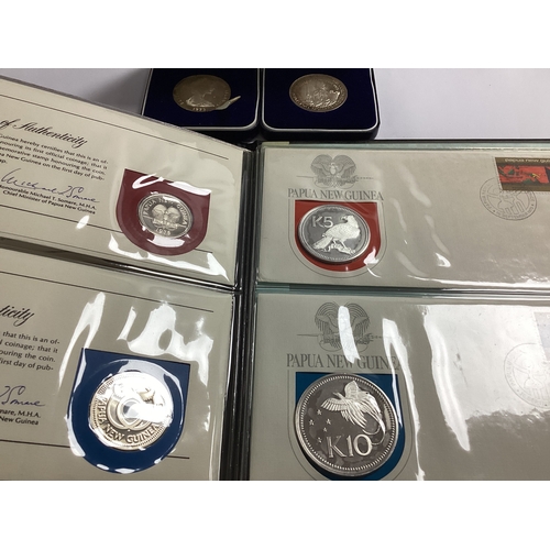 448 - Two 1973 Silver Cook Islands $2 Coins, together with a Papua New Guinea 1975 proof coin set, include... 