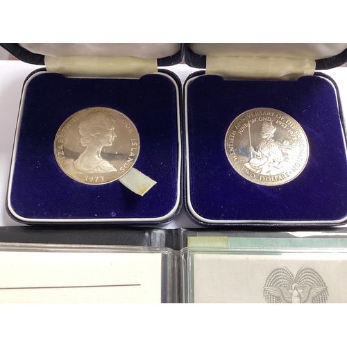 448 - Two 1973 Silver Cook Islands $2 Coins, together with a Papua New Guinea 1975 proof coin set, include... 