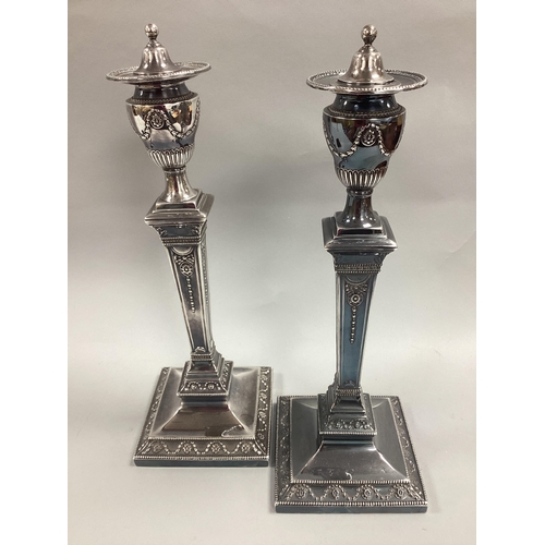 11 - A Pair of HE&Co Electroplated Candlesticks, each of Classical form, detailed in relief with tied rib... 