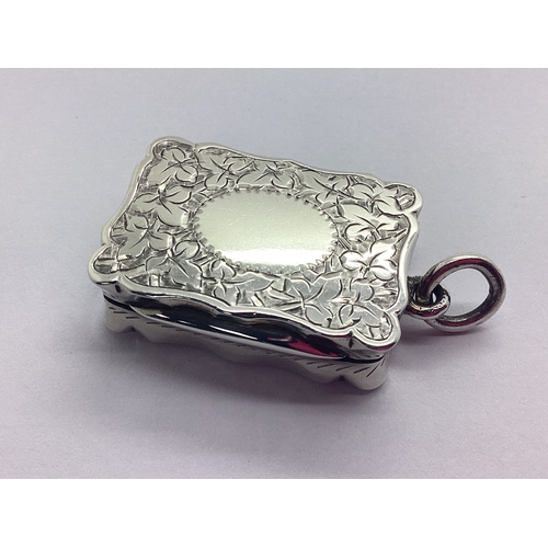 135 - A Hallmarked Silver Vinaigrette, CC, Birmingham 1892, of shaped rectangular form allover leaf engrav... 