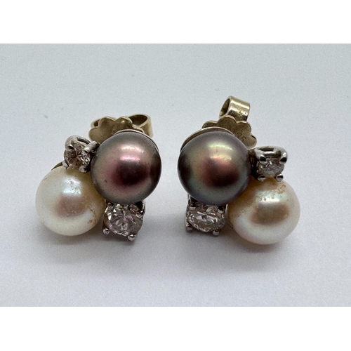 159 - A Pair of Freshwater Pearl and Diamond Set Earrings, the asymetrical claw set diamonds between peaco... 