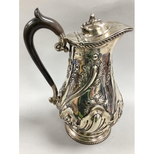 22 - A Decorative Hallmarked Silver Water Jug, BB, Birmingham 1902, of baluster form, allover detailed in... 