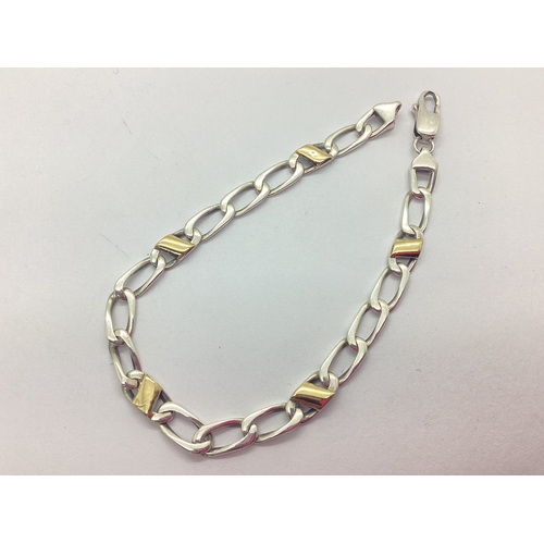 230 - A Fancy Curb Link Bracelet, with applied panels stamped 