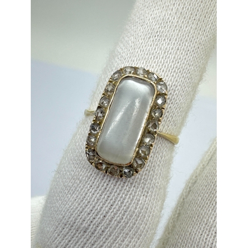 257 - An Antique Moonstone and Diamond Rectangular Cluster Ring, the cabochon moonstone collet set to the ... 