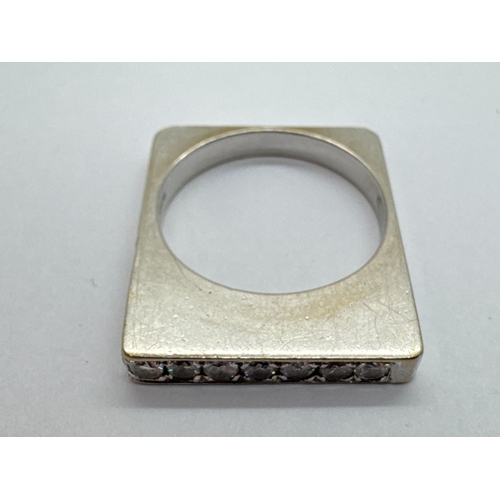 259 - An Unusual 18ct White Gold Diamond Set Rectangular Flat Ring, line set to top and part of one side w... 