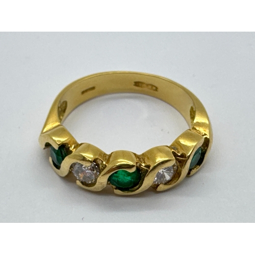 263 - A Modern 18ct Gold Emerald and Diamond Five Stone Ring, the uniform brilliant cut diamonds and circu... 