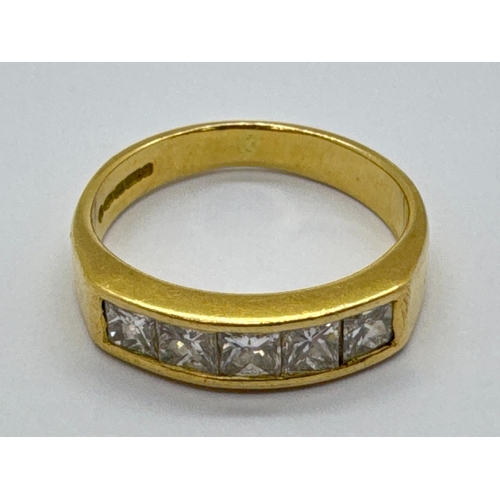 264 - An 18ct Gold Five Stone Diamond Ring, the princess cut diamonds, inset between wide tapered shoulder... 