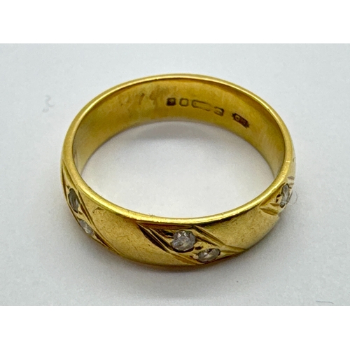 265 - An 18ct Gold Diamond Inset Band, the collet set diamonds within geometrical style surround, to plain... 