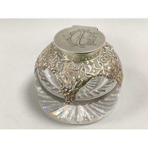 27 - A Hallmarked Silver Mounted Clear Glass Inkwell, (marks rubbed) Birmingham 1903, the flat hinged lid... 