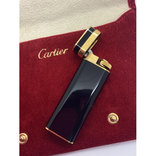 300 - Cartier; A Gold Plated and Black Lighter, numbered 