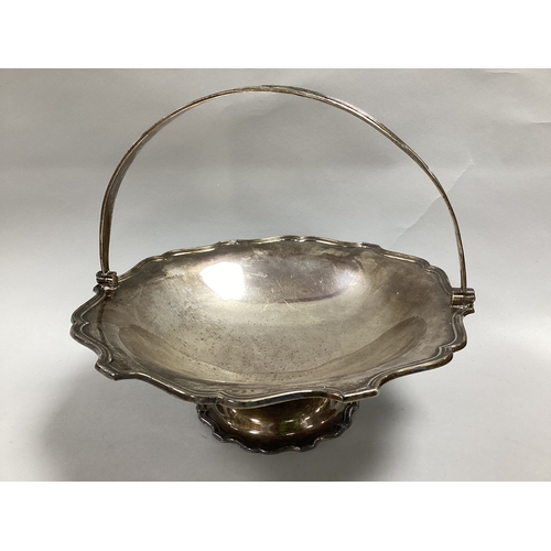 31 - A Hallmarked Silver Swing Handled Basket, (makers mark rubbed), London 1919, of circular form with r... 