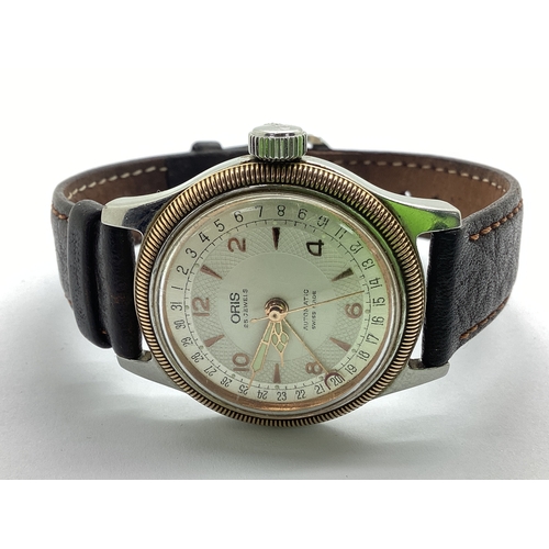 318 - Oris; Two-Tone 25 Jewels Pointer Date Automatic Wristwatch, the signed champagne dial with gilted ma... 