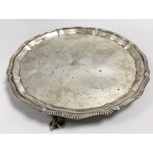 52 - A Hallmarked Silver Waiter, Mappin & Webb, Sheffield 1933, of shaped circular form with gadrooned ed... 