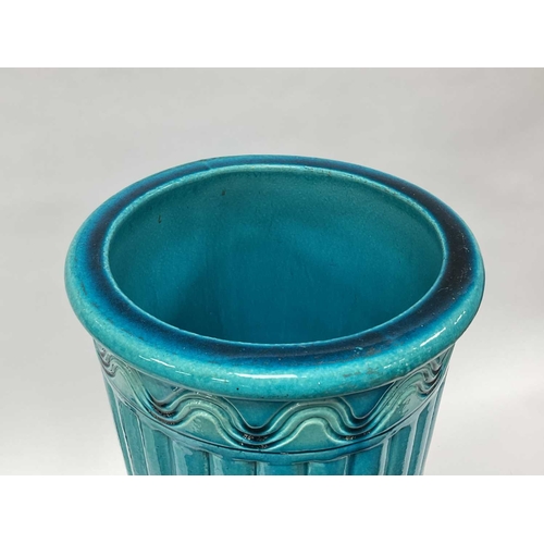 1123 - A Burmantofts Pottery Faience Stick Stand, decorated in a turquoise glaze, the cylindrical body moul... 