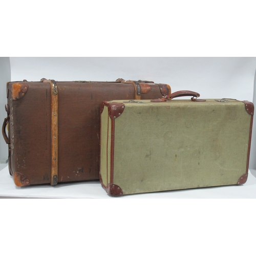 1119 - Green Canvas Suitcase with corner mounts and leather handle 72cm wide, a larger example with leather... 