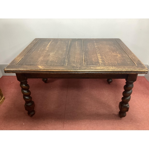 1538 - A 1930's Oak Wind-Out Table, raised on barley twist and block supports, 135cm wide.