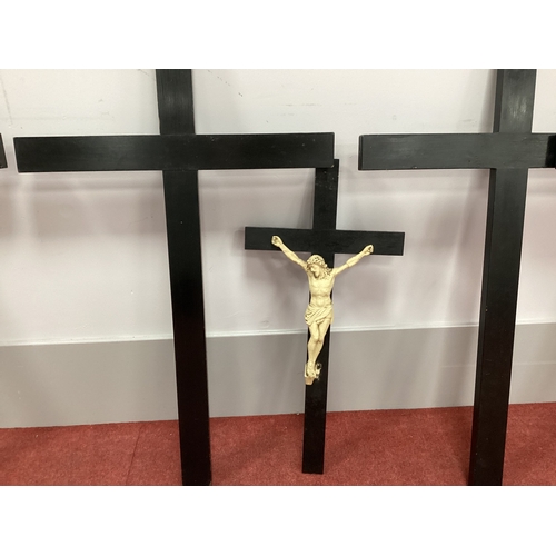 1550 - Six Black Painted Wooden Crosses, one with a figure of Christ attached, 67-100cm long. (6)