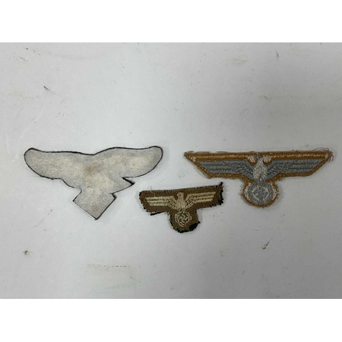 1300 - Collectables, reproduction German Armed Forces Insignia, including Demjansk Campaign shield and belt... 