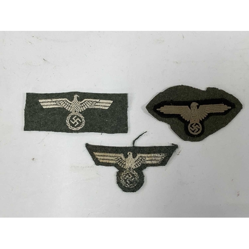 1300 - Collectables, reproduction German Armed Forces Insignia, including Demjansk Campaign shield and belt... 