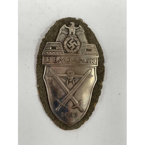1300 - Collectables, reproduction German Armed Forces Insignia, including Demjansk Campaign shield and belt... 