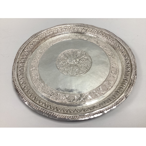 4 - A Highly Decorative Middle Eastern Circular Plaque / Tray, central foliate panel in relief, within t... 